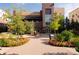 Beautifully landscaped entrance of a brick building with colorful flower beds and lush greenery at 3701 Arapahoe Ave # 304, Boulder, CO 80303