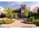 Beautiful building front entrance surrounded by colorful flowers and charming landscaping at 3701 Arapahoe Ave # 304, Boulder, CO 80303