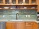 Bright kitchen features wood cabinets, stainless appliances, modern faucet, and tile backsplash at 3701 Arapahoe Ave # 304, Boulder, CO 80303