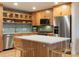 Bright kitchen features wood cabinets, stainless appliances, tile backsplash and center island with bar seating at 3701 Arapahoe Ave # 304, Boulder, CO 80303