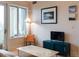 Cozy living room with hardwood floors, natural light, access to balcony, and contemporary decor at 3701 Arapahoe Ave # 304, Boulder, CO 80303