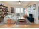 Inviting living room with hardwood floors, floor to ceiling bookshelves, comfortable seating, and natural light at 3701 Arapahoe Ave # 304, Boulder, CO 80303
