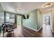 Bedroom with hardwood floors, green walls, a window with blinds and chairs with blankets at 5624 Killdeer St, Brighton, CO 80601