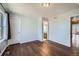 A bedroom with hardwood floors, light blue walls, and natural light at 5624 Killdeer St, Brighton, CO 80601