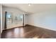 A bright bedroom with hardwood floors and a glass panel door to a balcony at 5624 Killdeer St, Brighton, CO 80601