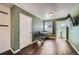 Bedroom with hardwood floors, green walls, a window with blinds and chairs with blankets at 5624 Killdeer St, Brighton, CO 80601