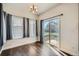 Bright dining area featuring hardwood floors, a chandelier, and sliding doors to the yard at 5624 Killdeer St, Brighton, CO 80601