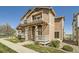 Beautiful two-story home featuring a cozy front porch and professionally landscaped yard at 5624 Killdeer St, Brighton, CO 80601