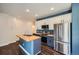 Modern kitchen featuring stainless steel appliances, butcher block island, and stylish cabinetry at 5624 Killdeer St, Brighton, CO 80601