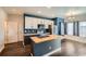 Modern kitchen with an island, stainless steel appliances and dark wood floors at 5624 Killdeer St, Brighton, CO 80601