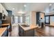 Kitchen featuring an island, stainless steel appliances, and access to a fireplace at 5624 Killdeer St, Brighton, CO 80601