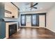 Cozy living room featuring a stylish fireplace, wood floors, and a door leading outdoors at 5624 Killdeer St, Brighton, CO 80601