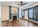 Bright living room featuring a fireplace, hardwood floors, and a walk-out door to the outside at 5624 Killdeer St, Brighton, CO 80601