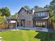 Beautiful backyard featuring a stone patio, built-in grill, pergola, and lush lawn, perfect for outdoor entertaining at 2511 S Columbine St, Denver, CO 80210