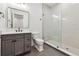 Contemporary bathroom featuring sleek vanity, glass-enclosed shower, and neutral tiling at 2511 S Columbine St, Denver, CO 80210