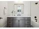 Modern bathroom features gray vanity, white countertop, and black fixtures at 2511 S Columbine St, Denver, CO 80210