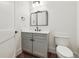 Charming bathroom with gray vanity, white countertop, and stylish fixtures at 2511 S Columbine St, Denver, CO 80210