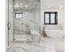 Stunning bathroom with glass shower, soaking tub, and elegant white marble tile throughout at 2511 S Columbine St, Denver, CO 80210