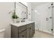 Stylish bathroom featuring a gray vanity, patterned tile, and glass-enclosed shower at 2511 S Columbine St, Denver, CO 80210