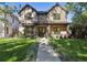 Charming brick home featuring a well-manicured lawn and inviting walkway that leads to the front entryway at 2511 S Columbine St, Denver, CO 80210