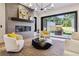 Inviting living room boasts a modern fireplace, stylish decor, and seamless indoor-outdoor flow to the backyard at 2511 S Columbine St, Denver, CO 80210