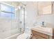 Modern bathroom featuring marble wall tiles and updated sink and shower fixtures at 3254 S Bannock St, Englewood, CO 80110