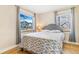 Bright bedroom with hardwood floors, large window and gray accents at 3254 S Bannock St, Englewood, CO 80110