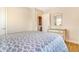 Neutral bedroom featuring hardwood floors, an accent mirror, and an open doorway at 3254 S Bannock St, Englewood, CO 80110