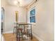 Cozy dining area with a rustic table, seating for four, and a window with natural light at 3254 S Bannock St, Englewood, CO 80110