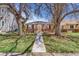 Charming brick home with a well-manicured front yard and a walkway leading to the entrance at 3254 S Bannock St, Englewood, CO 80110