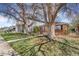 Lovely home with a lush green lawn, mature trees, and sidewalk at 3254 S Bannock St, Englewood, CO 80110