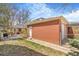 Detached two car brick garage with backyard, patio, and home in the background at 3254 S Bannock St, Englewood, CO 80110