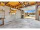 Empty two car garage with block walls and a view of the street outside at 3254 S Bannock St, Englewood, CO 80110