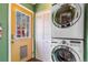 Practical laundry area featuring stacked washer and dryer, plus a rear access door at 3254 S Bannock St, Englewood, CO 80110