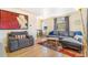 Cozy living room featuring hardwood floors, a comfortable sofa, and natural light at 3254 S Bannock St, Englewood, CO 80110