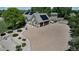 Aerial view of a house with solar panels, a paved driveway, and manicured landscaping at 6633 E 166Th Pl, Brighton, CO 80602