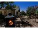 Backyard patio featuring an outdoor fireplace and wooden seating, perfect for entertaining at 6633 E 166Th Pl, Brighton, CO 80602