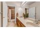 Bathroom with double vanity sinks, wood cabinets, and a separate shower room at 6633 E 166Th Pl, Brighton, CO 80602