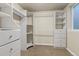Walk-in closet featuring built-in shelving and drawers for optimal storage at 6633 E 166Th Pl, Brighton, CO 80602