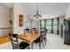 Spacious dining room features a large wooden table, pendant lighting, and multiple windows at 6633 E 166Th Pl, Brighton, CO 80602