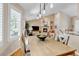Inviting dining room featuring a fireplace and a large window with white shutters at 6633 E 166Th Pl, Brighton, CO 80602