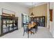 Elegant dining room boasts dark wood furniture, neutral colors, and ample natural light at 6633 E 166Th Pl, Brighton, CO 80602