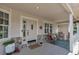 Charming front porch with rocking chairs, a welcome mat, and a view into the home at 6633 E 166Th Pl, Brighton, CO 80602