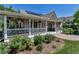 Inviting porch features a cozy seating area, hanging plants, and charming curb appeal at 6633 E 166Th Pl, Brighton, CO 80602