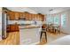 Modern kitchen with wood floors, island seating, stainless steel appliances and backsplash at 6633 E 166Th Pl, Brighton, CO 80602