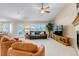 Comfortable living room features a fireplace, ceiling fan, and a black leather couch at 6633 E 166Th Pl, Brighton, CO 80602