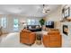 Inviting living room features neutral paint, large windows, fireplace, and a ceiling fan at 6633 E 166Th Pl, Brighton, CO 80602