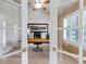 Office space featuring French doors, neutral carpeting, a ceiling fan, and a large window with plantation shutters at 6633 E 166Th Pl, Brighton, CO 80602