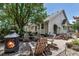 A cozy backyard patio featuring ample seating around a fire pit on the brick surface at 6633 E 166Th Pl, Brighton, CO 80602