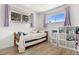 Well-lit bedroom with shelves and two large windows at 10470 Pennsylvania St, Northglenn, CO 80233